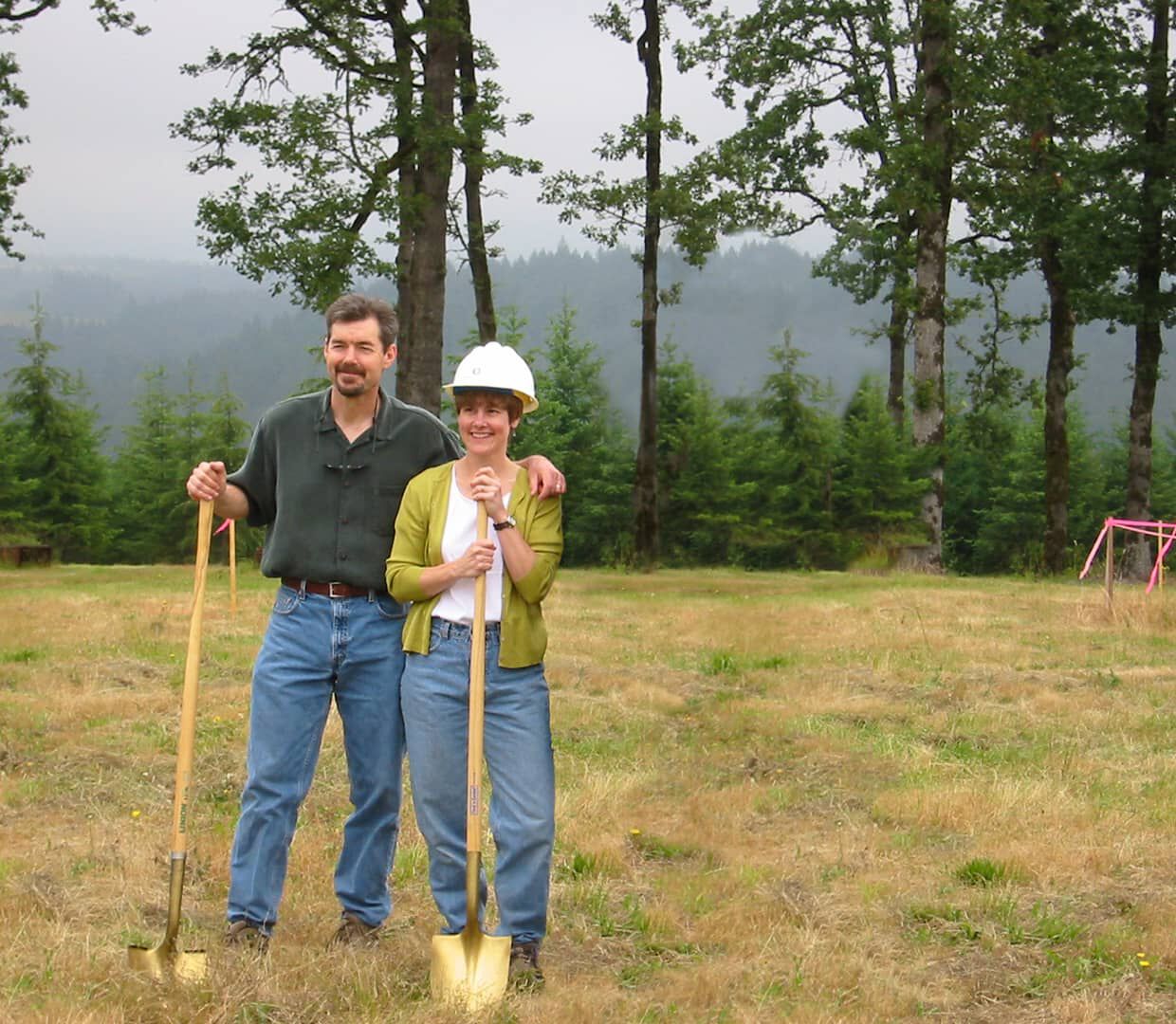 Lyn and Ron Penner posing with shovels and hard hats on.