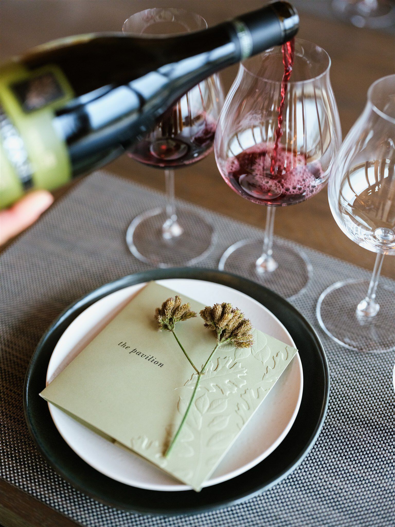 Pouring a Legacy Tasting Pinot Noir into a glass