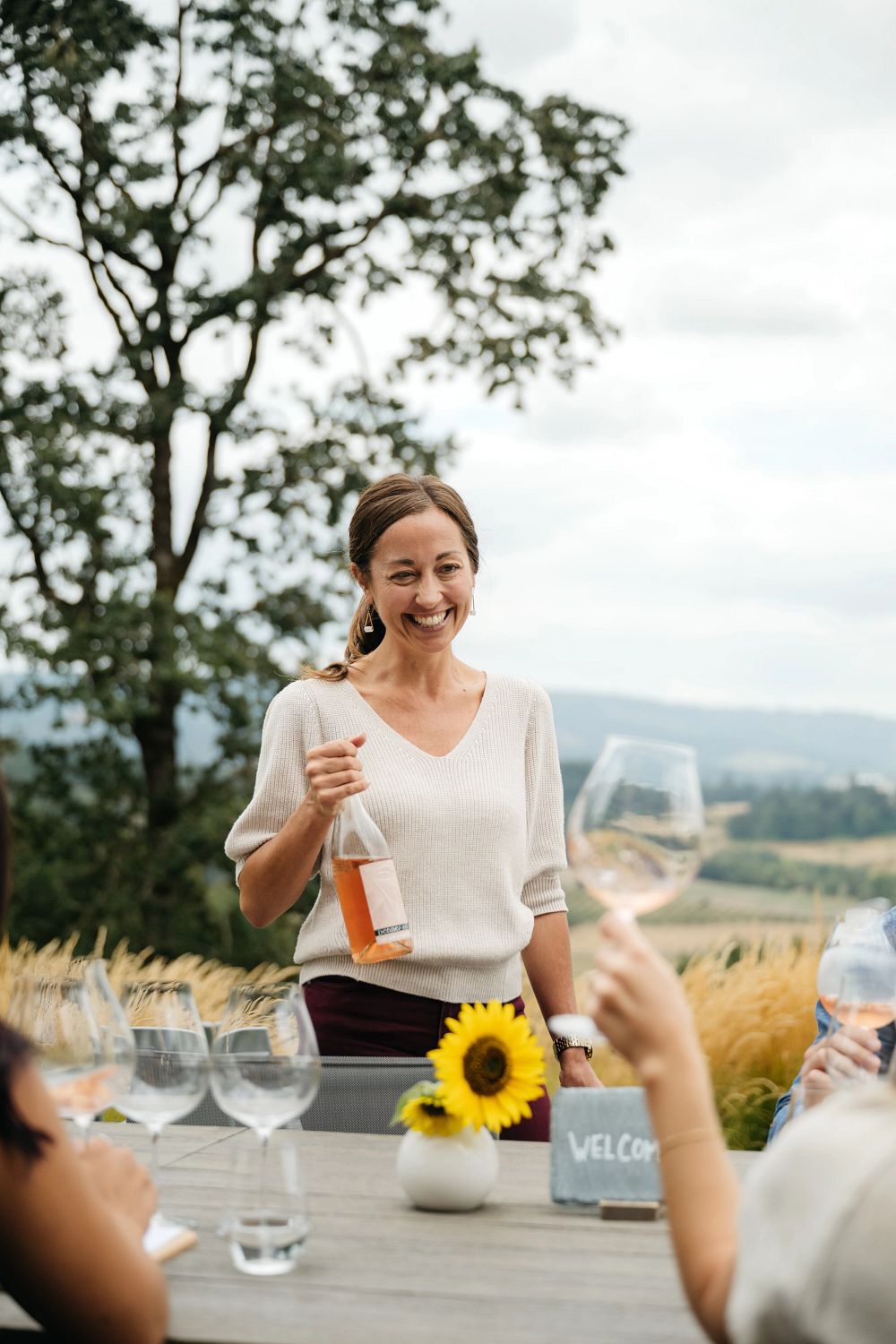 A couple drinking a glass of Penner-ash wine in the Penner-Ash Estate Garden. A couple drinking a glass of Penner-ash wine in the Penner-Ash Estate Garden.