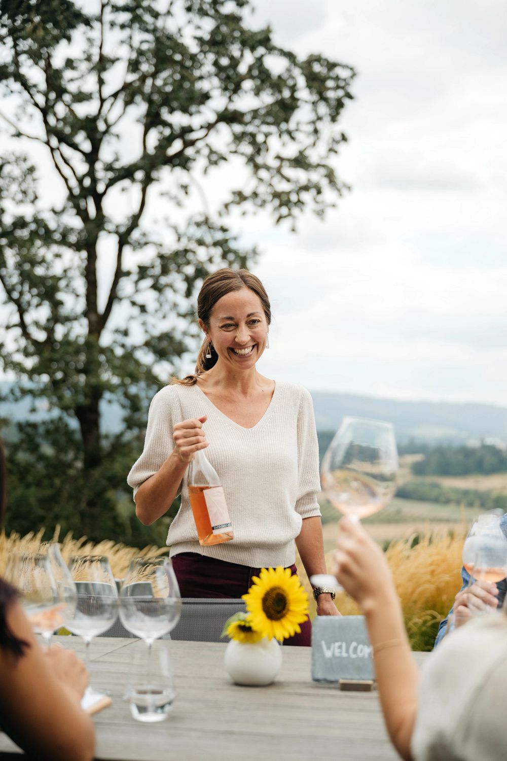 Penner-Ash Estate Manager pouring wine for a tasting experience.